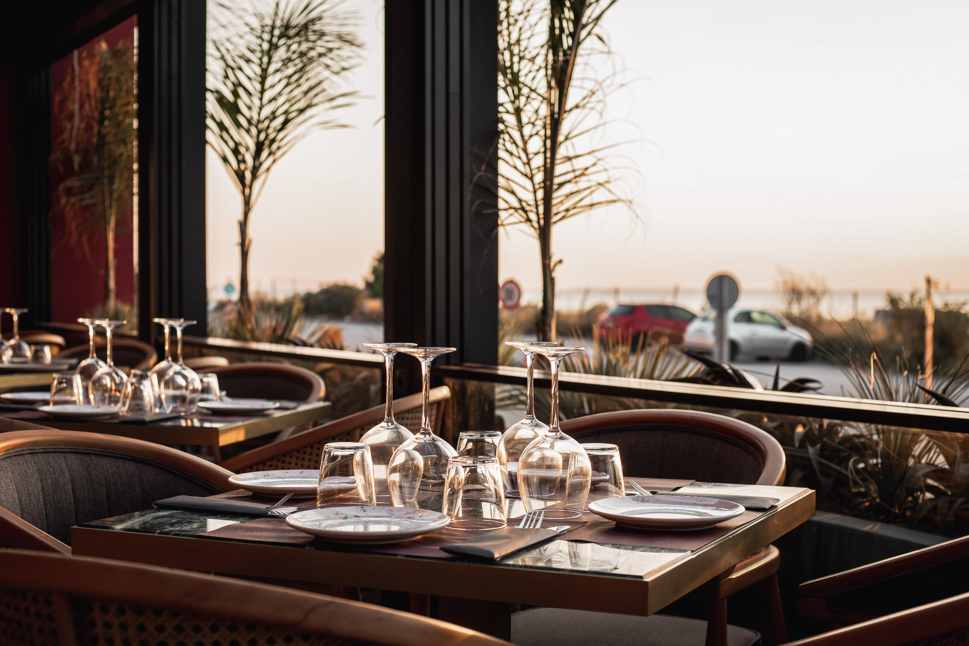 Outdoor terrace seating at sunset overlooking the marina